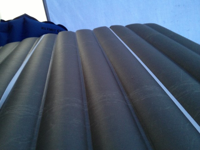 Backside of a NeoAir All Season pad with Monkey Pillow pad straps, attached